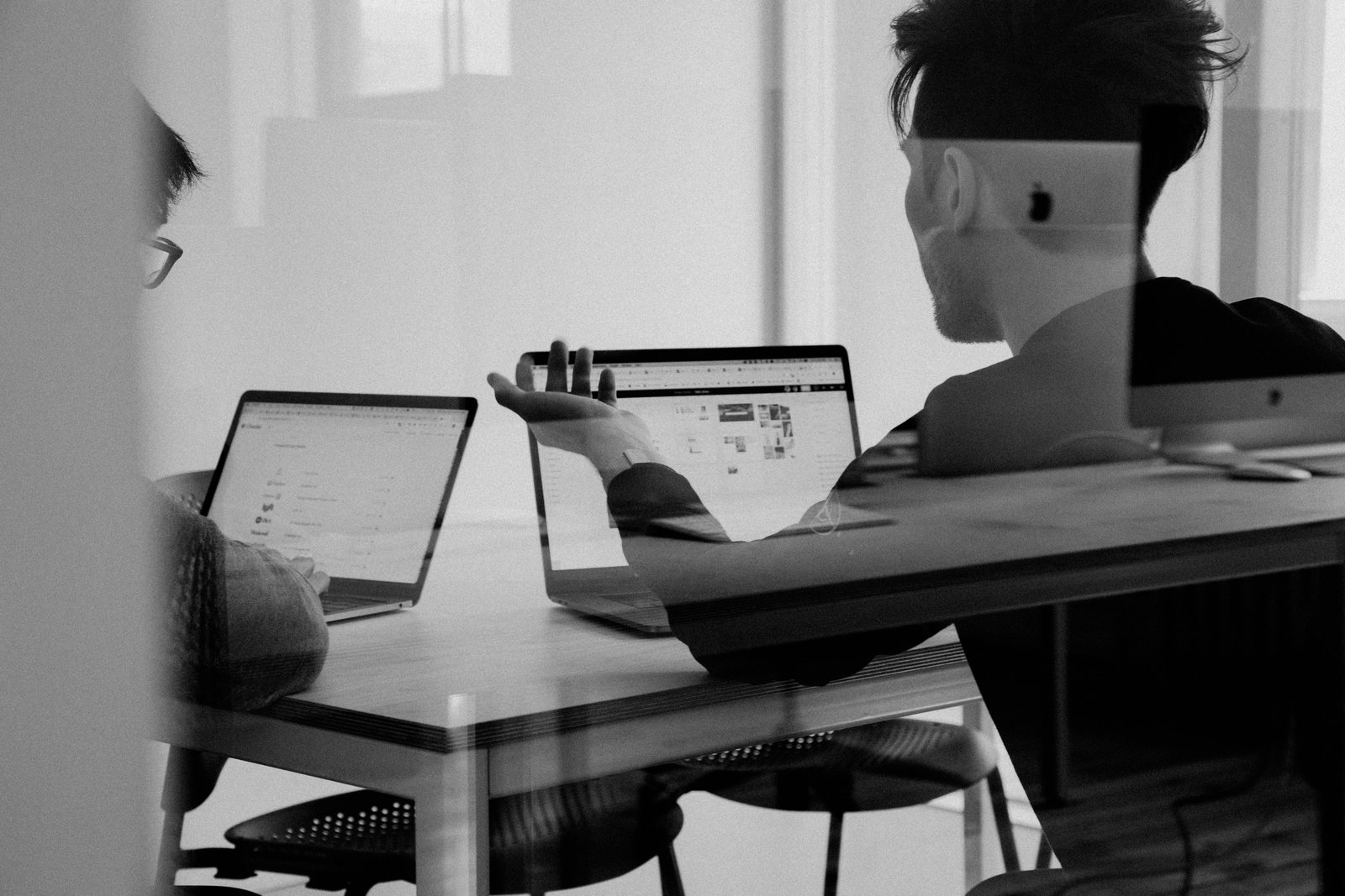 An adviser and a client reviewing application documents together
